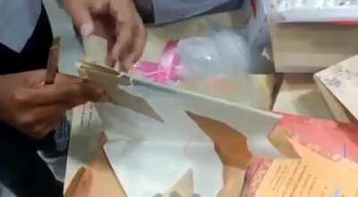 at an airport, a person was carrying these wedding cards containing some coke. got caught by the security.