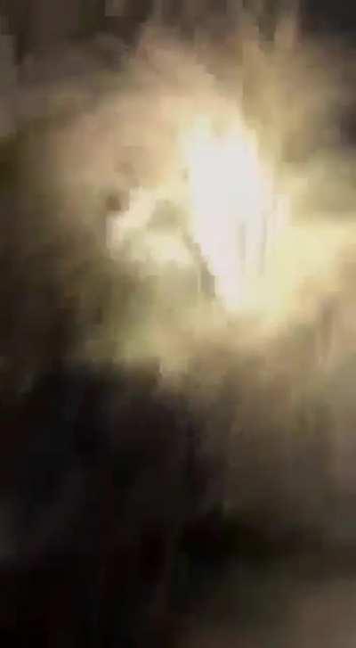 A field caretaker saw white lights on a nearby field and when he went to investigate he found circles of burnt grass and a Gray sitting up.