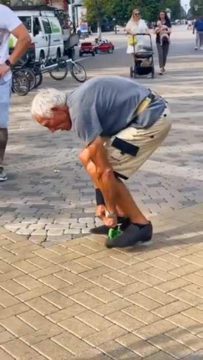 This old man riding a tiny little bike.