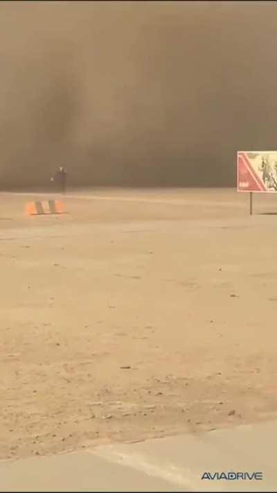 A Russian soldier Forrest Gumps unsuccessfully to escape from dust cloud raised by passing Mi-26 helicopters