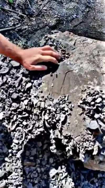 This stone effortlessly crumbling into smaller rocks