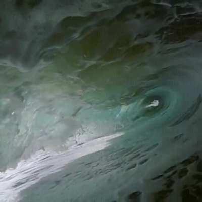 Wave devours the photographer