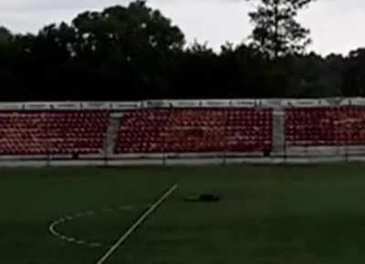 Soccer player suddenly struck by lightning as soon as he kicks the ball.
