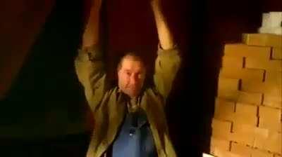 Smashing a brick on his head