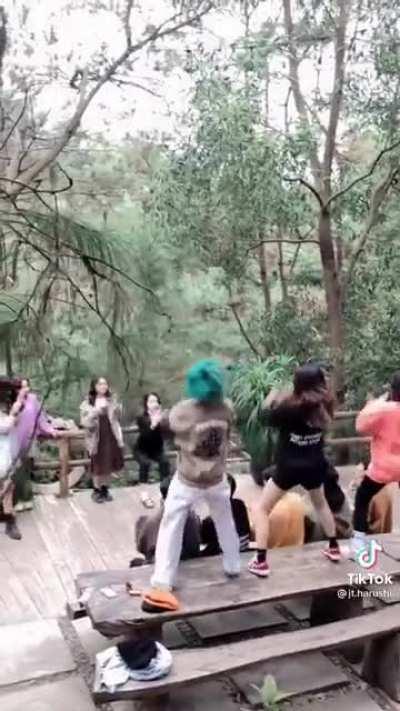 A group of young people dancing on a table while traveling to make a TikTok video