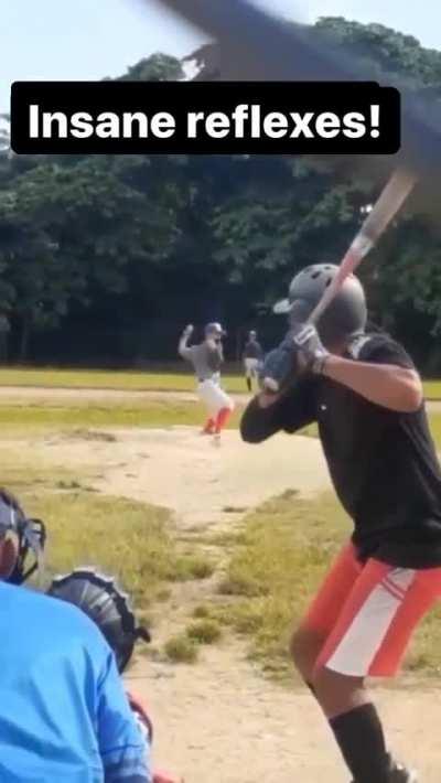 Insane behind the back catch by pitcher