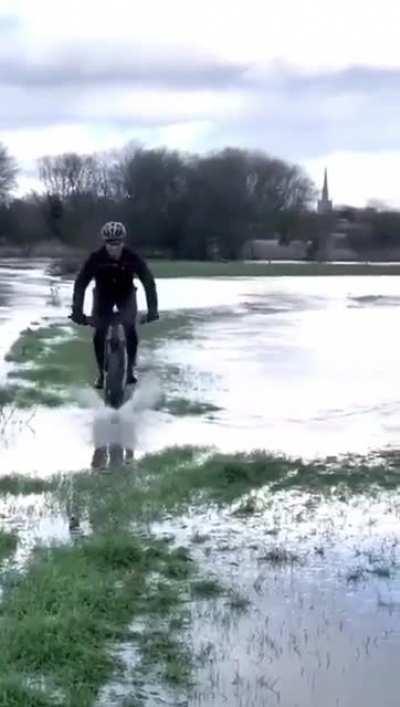 WCGW cycling across a flooded field.