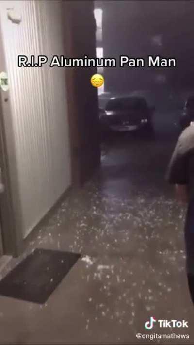 A man runs out into a serious storm holding an aluminum pan over his head. Lightning strikes moments later.