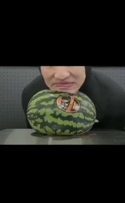 man crushes a watermelon with his jaw