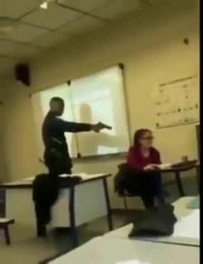 Pointing a gun at the teacher