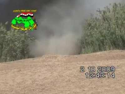 Iraqi resistence group planting IED on the road against USA armored vehicle. 2009