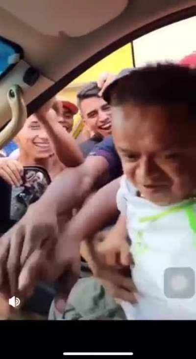 Mob of people steal a little person