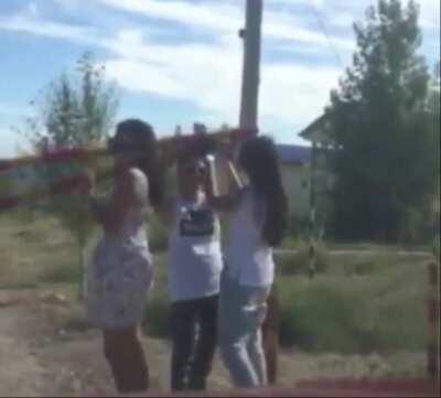 Girls being creative while opennimg the gate