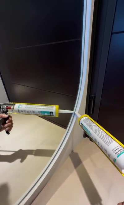 Caulking around a mirror
