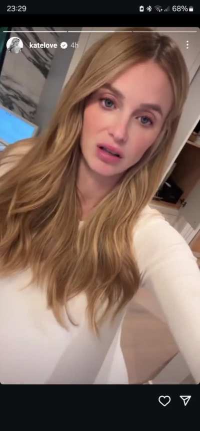 Kate Love rubbing her pregnant belly