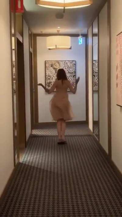 Girl dancing in the middle of the hallway