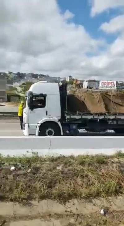 Crazy man tries to stop a truck from passing a protest.