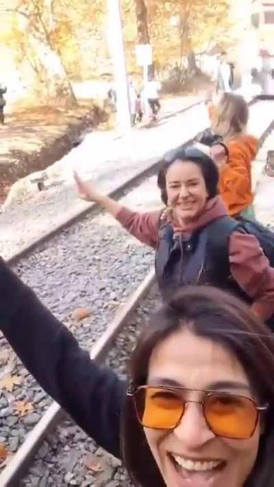 Taking a selfie with an oncoming train