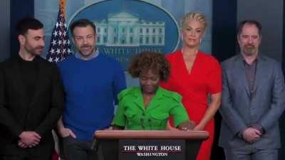 Cast of 'Ted Lasso' awkwardly observe shouting match between angry reporter and his colleagues in White House briefing room.