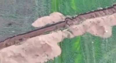 Russian soldier on the motorcycle tries jumping over anti-tank trench, but crashes into it and dies, May 2025, Ukraine