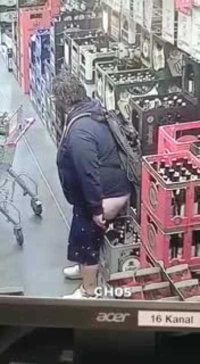 Man pooping in a supermarket caught on camera.