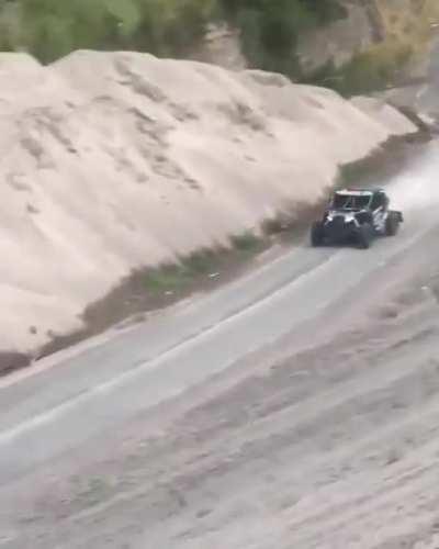 Let's stand next to a blind curve behind a hill during a rally race.
