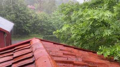 Summer rain falls on a clay tile roof. So happy for our roof overhang that provides enough protection to sit cosily in an open window and enjoy the show.