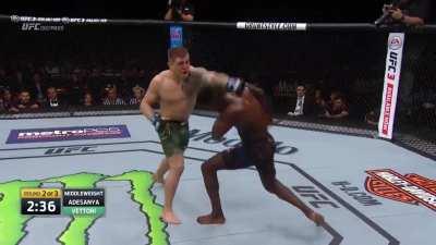 Israel Adesanya Slips, Rolls, & Lands A Right Hook While Moving Backwards On Marvin 