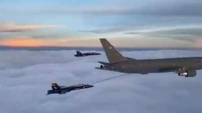Blue Angels refueling over cloud cover.