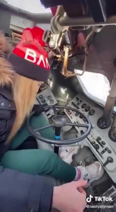 Ukranian woman teaching her people how to operate abandoned Russian tanks