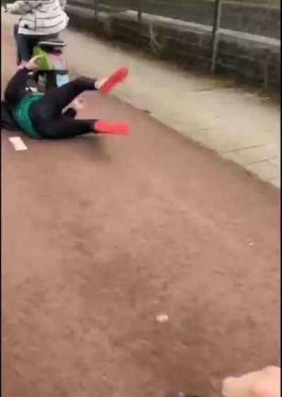 Standing on the back of a moving scooter