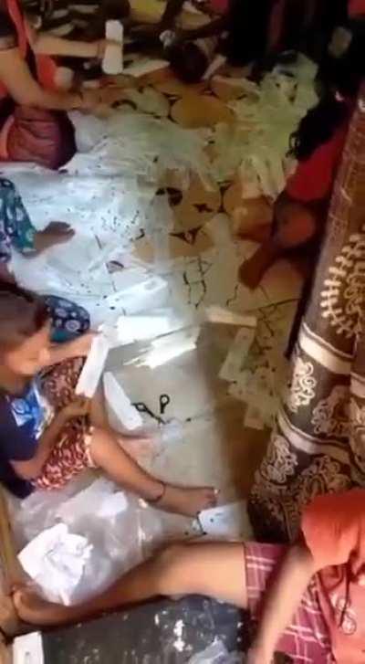 A rare glimpse of the inner sanctum of COVID-19 test kit creation. These kids are volunteering their child labor to produce the most sterile of test kits. Think of them as it goes up your nose.