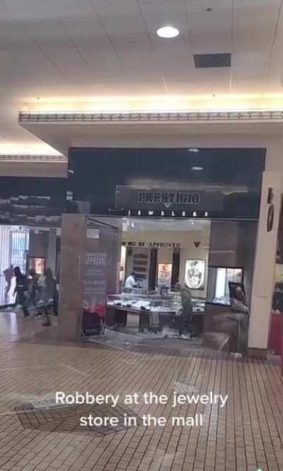 Group of people rob a jewelry store in the mall