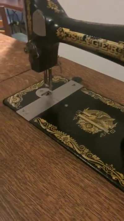 My antique Singer Sewing Machine that I recently restored and button epoxy table I made.