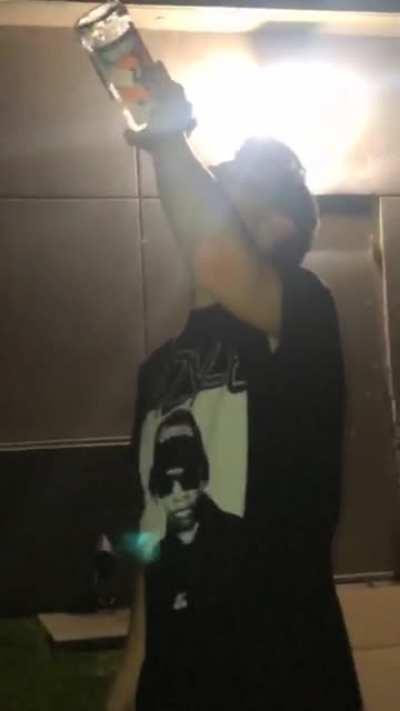 Throwing a glass bottle at a wall