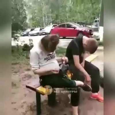 A pregnant woman lost in thought during broad daylight.