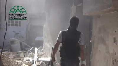 Members of Jaysh al-Islam take it in turns to shoot and bait return fire down an alleyway in Jobar, Damascus [Syria] (December 2013)