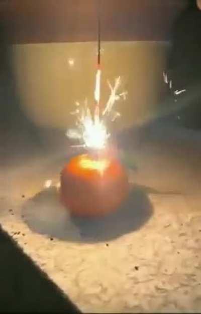 A mandarin set on fire