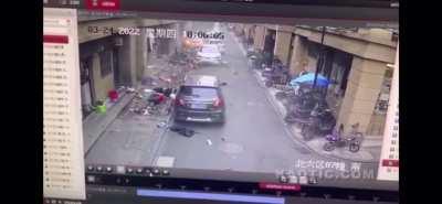 Car flattens everything in its path in China. The guy hit by the car is fucked up but can be seen crawling to a bystander for help. No idea of his condition.