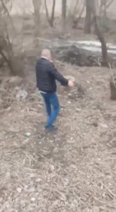 Ukrainian man relocating a mine with bare hands