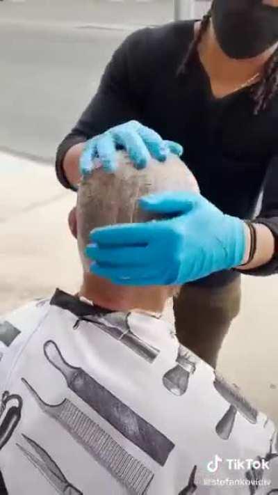 Giving a haircut to a homeless person