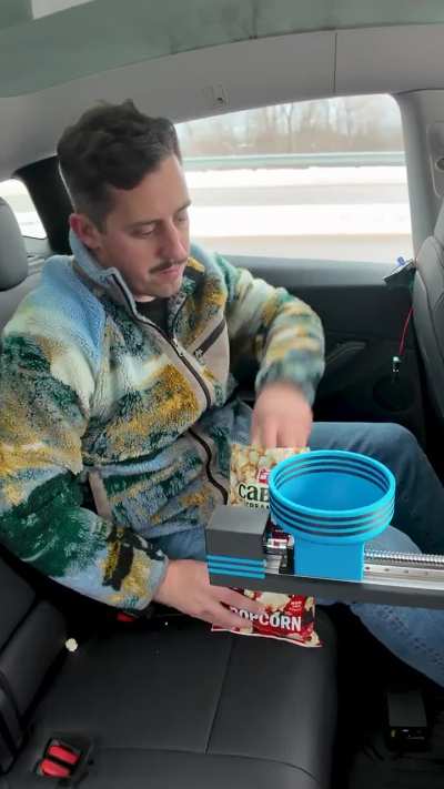 I make unnecessary things and today I built a device that delivers the good back seat snacks to the driver.