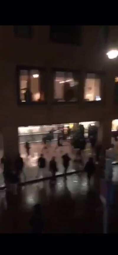 Dutch grocery store being looted during riot against curfew.