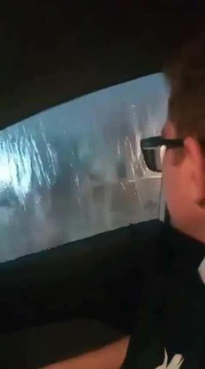 Car submerged in flooding while passengers causality talk about it: 