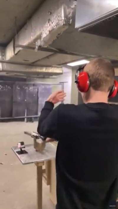 How not to shoot a revolver; guy bump fires and almost taps his head with the second shot.