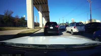 Car turns left from middle lane almost causing an accident.