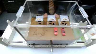 Liquefaction experiment shows effects of different foundations and hollow objects resurfacing (e.g. water pipes)