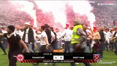 Frankfurt fans celebrating on the pitch after reaching their first European final in 42 years