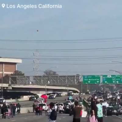 Los Angeles police, dressed in riot gear, are in a standoff as thousands of protesters march against ICE deportations