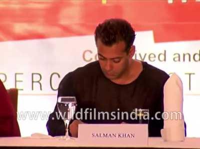 Salman Khan concentrating on his drawing in the middle of a press conference